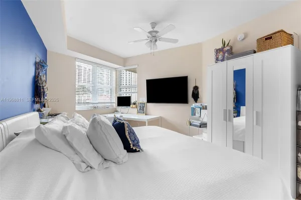 a bedroom with a bed and a flat screen tv