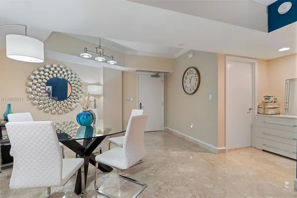 a view of a dining room and kitchen with furniture and a chandelier