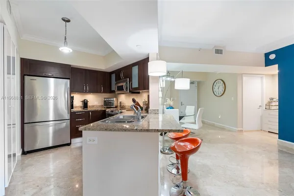 a kitchen with refrigerator and furniture