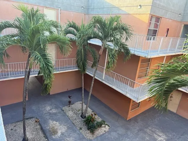 a view of a balcony with potted plants