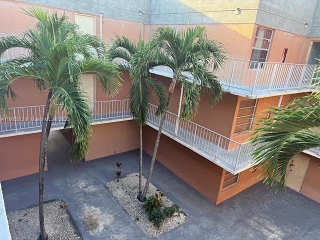 a view of a balcony with potted plants