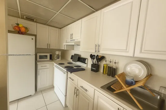 a kitchen with a sink appliances and cabinets