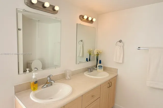 a bathroom with a double vanity sink and a mirror