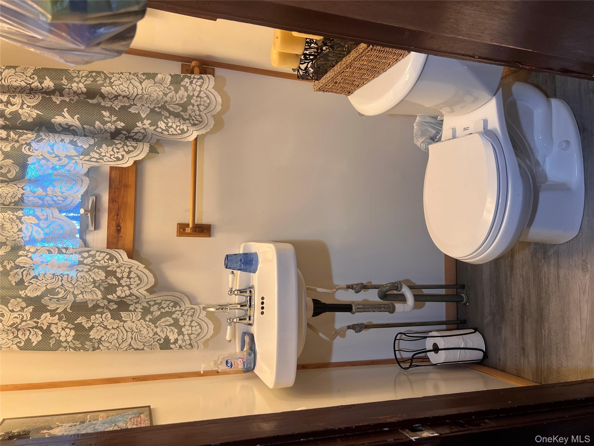 279 Cold Spring Road Monticello, NY 12701 - Photo 12 of 32 a bathroom with a sink and a toilet