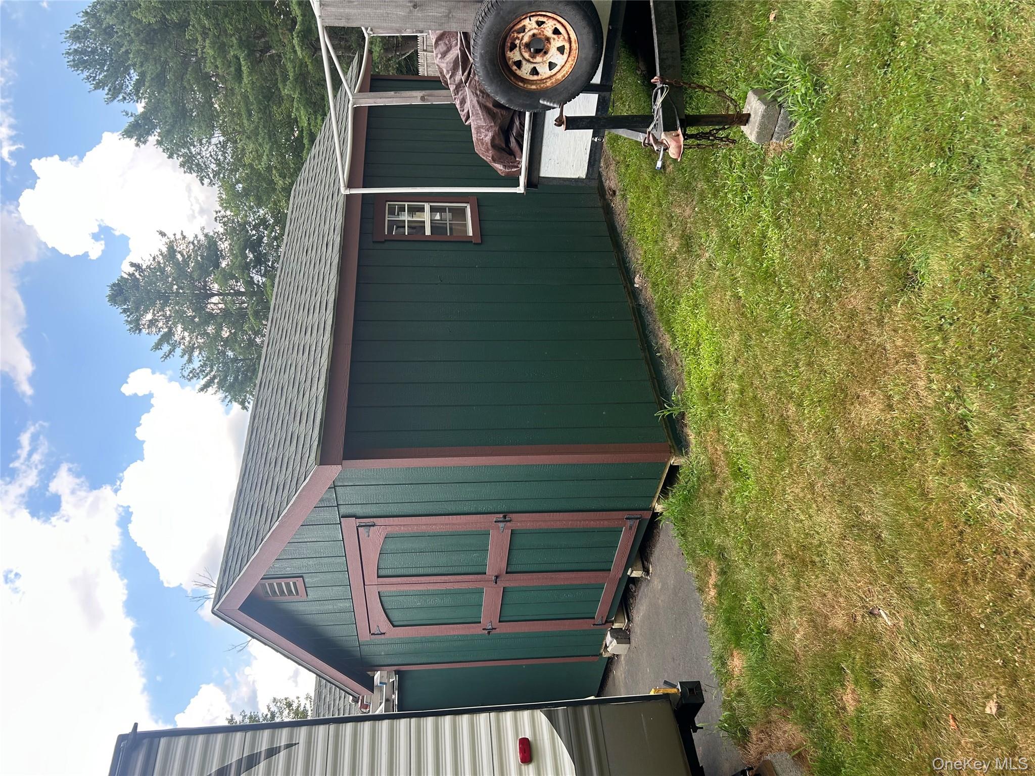 279 Cold Spring Road Monticello, NY 12701 - Photo 31 of 32 a backyard of a house with yard and garage