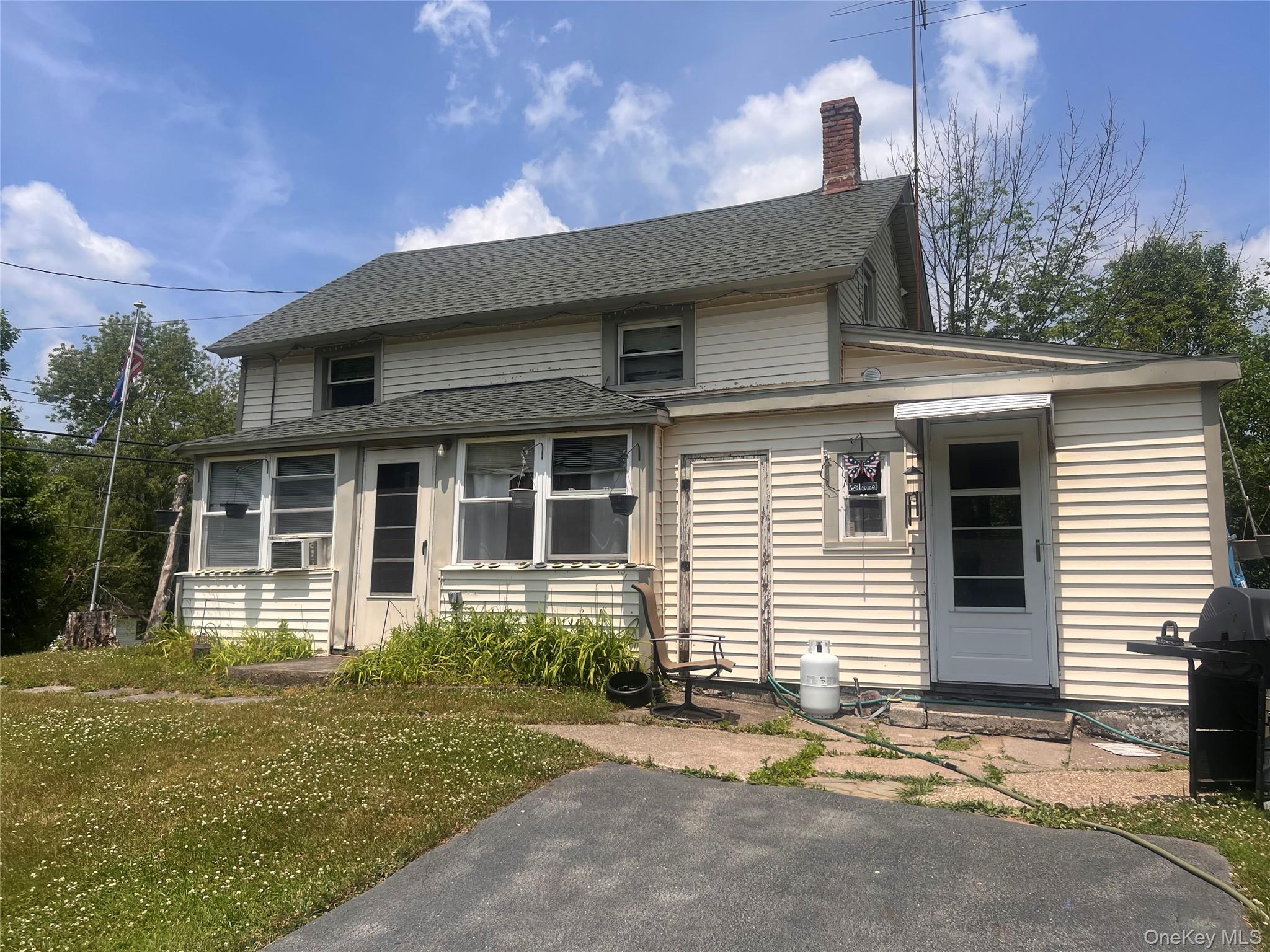279 Cold Spring Road Monticello, NY 12701 - Photo 5 of 32 a front view of a house with garden