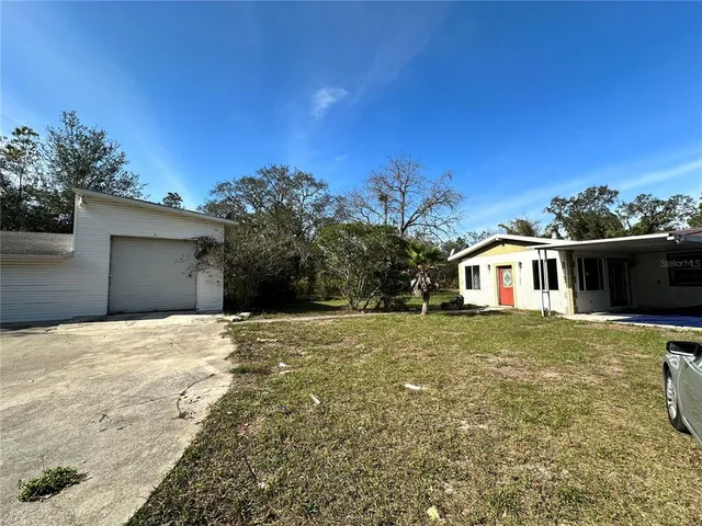 a view of a house with wooden floor and yard