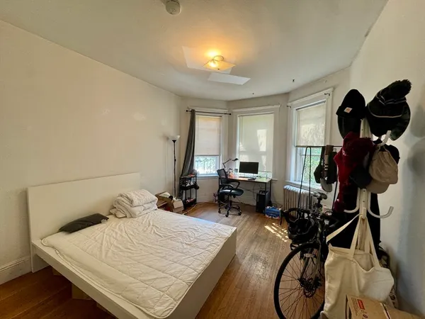 a bedroom with filled bed and a chandelier
