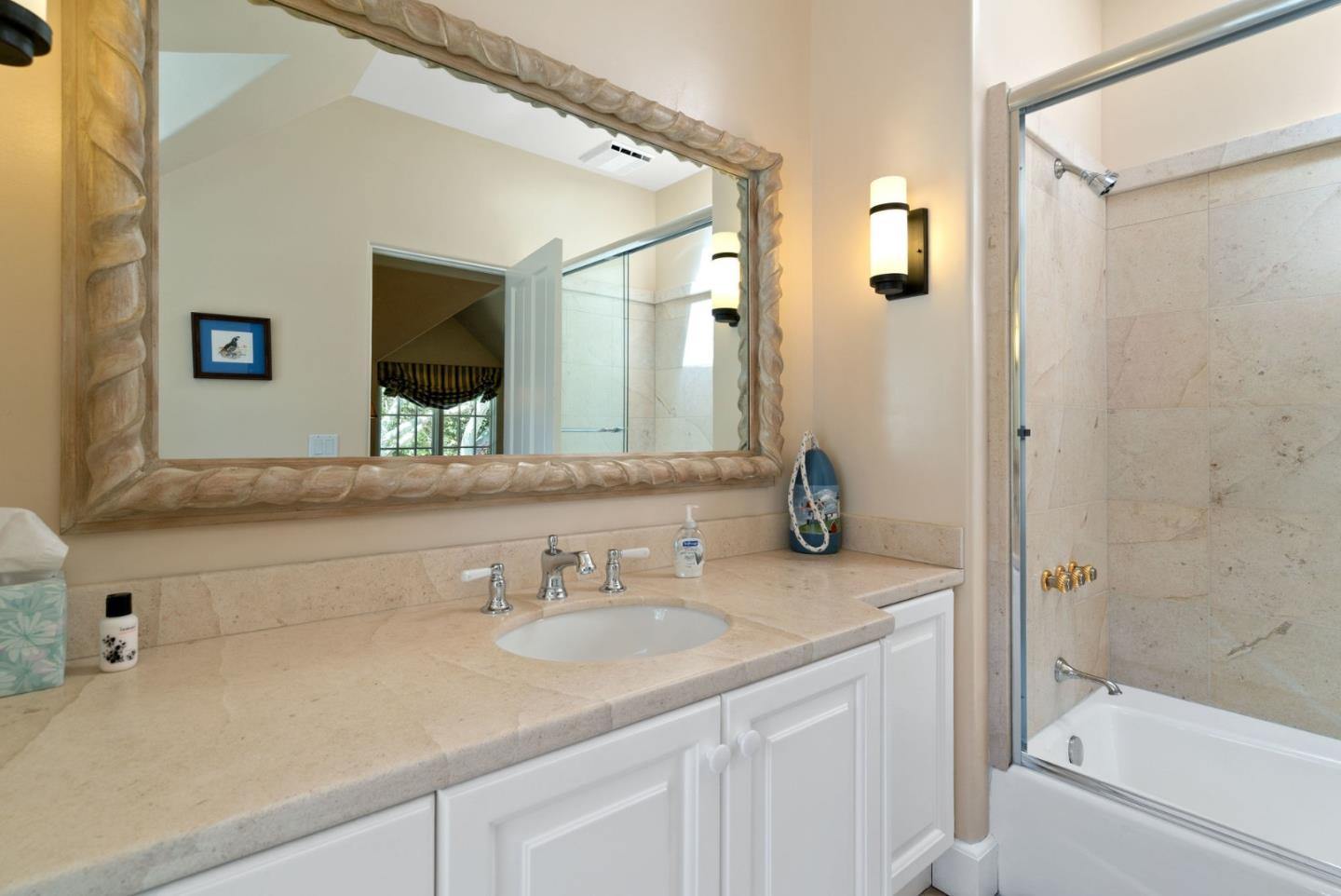 25951 Ridgewood Road Carmel, CA 93923 - Photo 25 of 32 a bathroom with a sink a toilet and shower