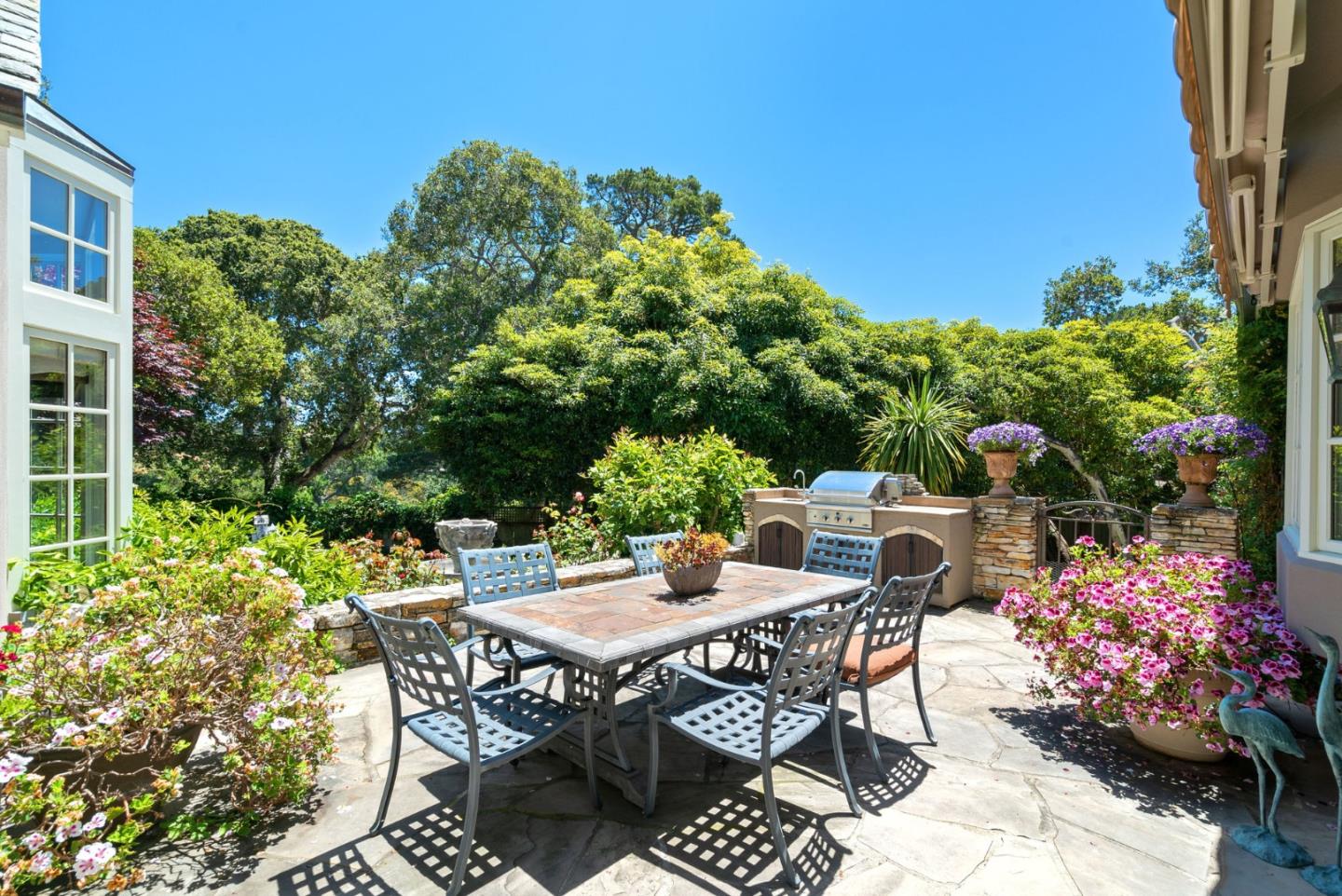 25951 Ridgewood Road Carmel, CA 93923 - Photo 29 of 32 a view of a chairs and table in a backyard