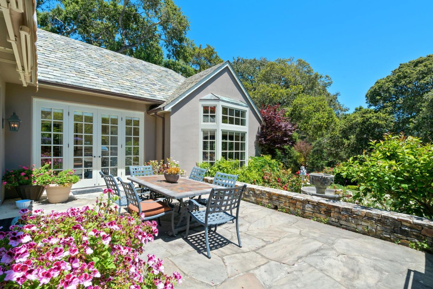 25951 Ridgewood Road Carmel, CA 93923 - Photo 30 of 32 a view of a house with backyard sitting area and garden