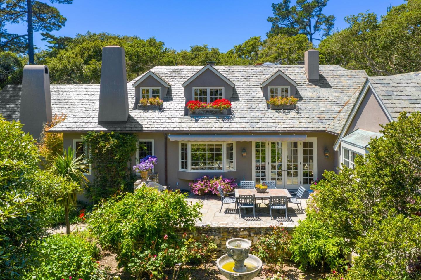 25951 Ridgewood Road Carmel, CA 93923 - Photo 5 of 32 a view of house with outdoor seating and mountain view