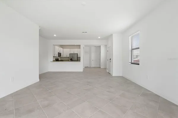 a view of a big room with closet and windows