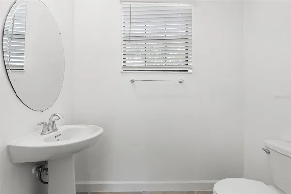 a bathroom with a sink toilet and a mirror