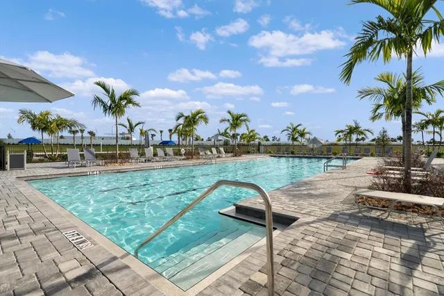 a view of outdoor space with swimming pool and seating