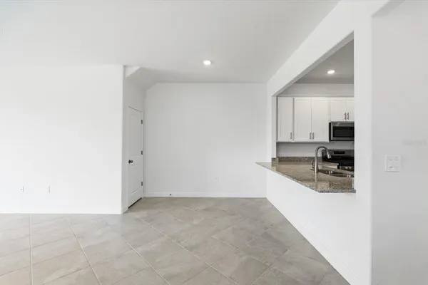 a kitchen with granite countertop a sink and cabinets