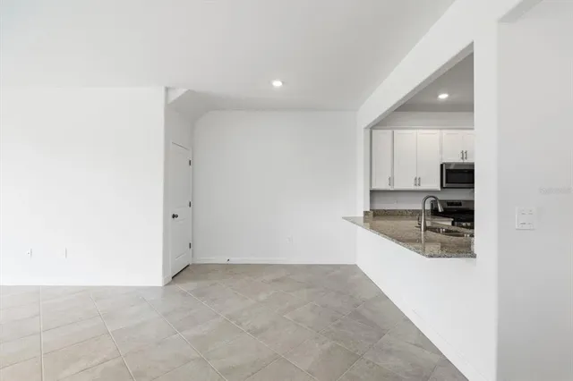 a kitchen with granite countertop a sink and cabinets