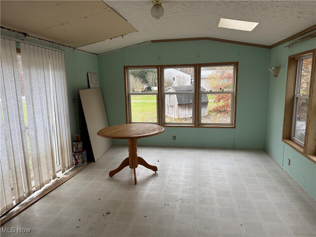 3690 Anderson Anthony Road Leavittsburg, OH 44430 - Photo 4 of 18 Spare room with tile patterned floors, lofted ceiling, a textured ceiling, and a skylight
