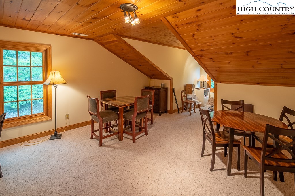 508 St Andrews Road Beech Mountain, NC 28604 - Photo 11 of 13 a dining room with furniture and a floor to ceiling window