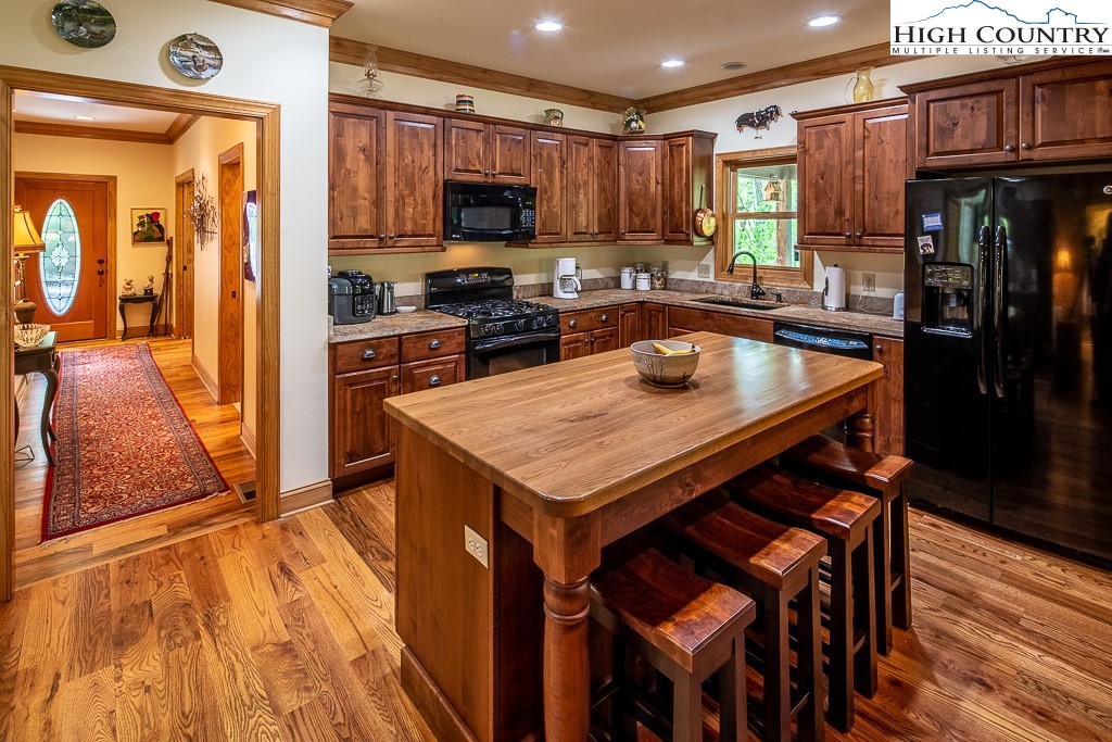 508 St Andrews Road Beech Mountain, NC 28604 - Photo 2 of 13 a kitchen with a stove a sink and a refrigerator