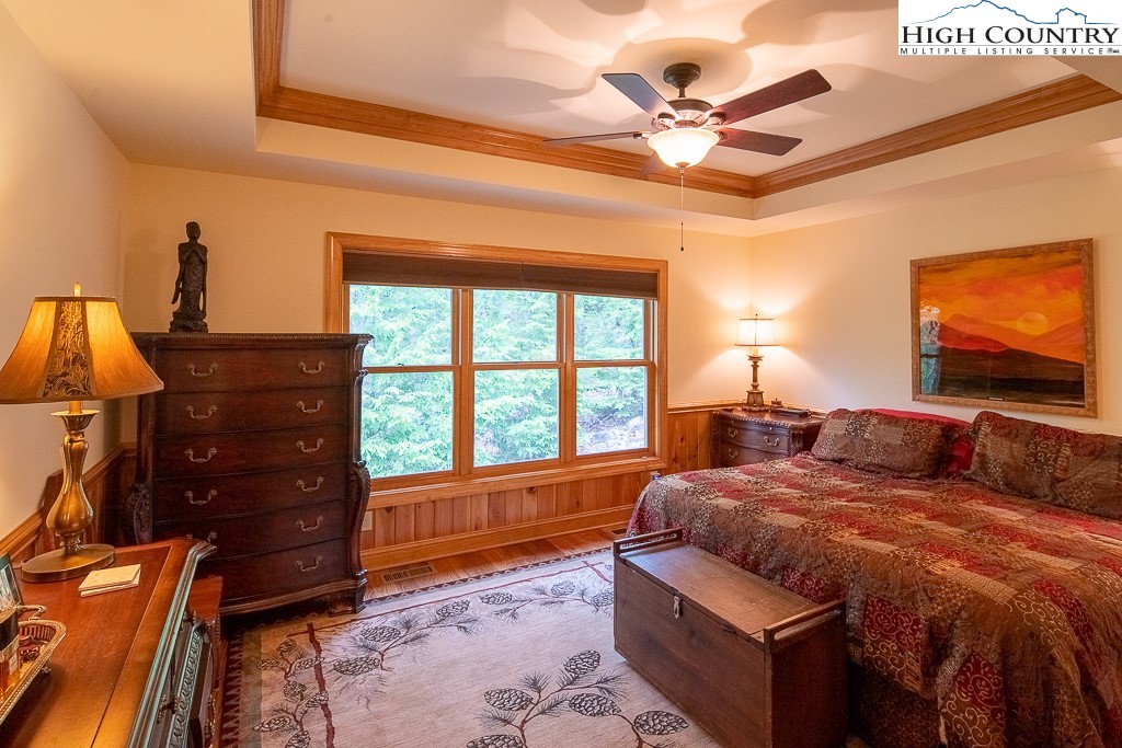 508 St Andrews Road Beech Mountain, NC 28604 - Photo 4 of 13 a bedroom with a bed and a dresser next to a window