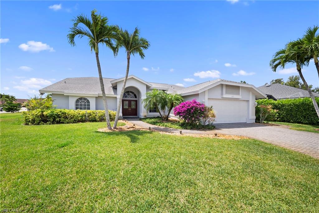 3971 Spring Garden Lane Estero, FL 33928 - Photo 1 of 31 a front view of house with yard and outdoor seating
