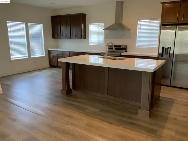 a room with wooden floor table and chairs