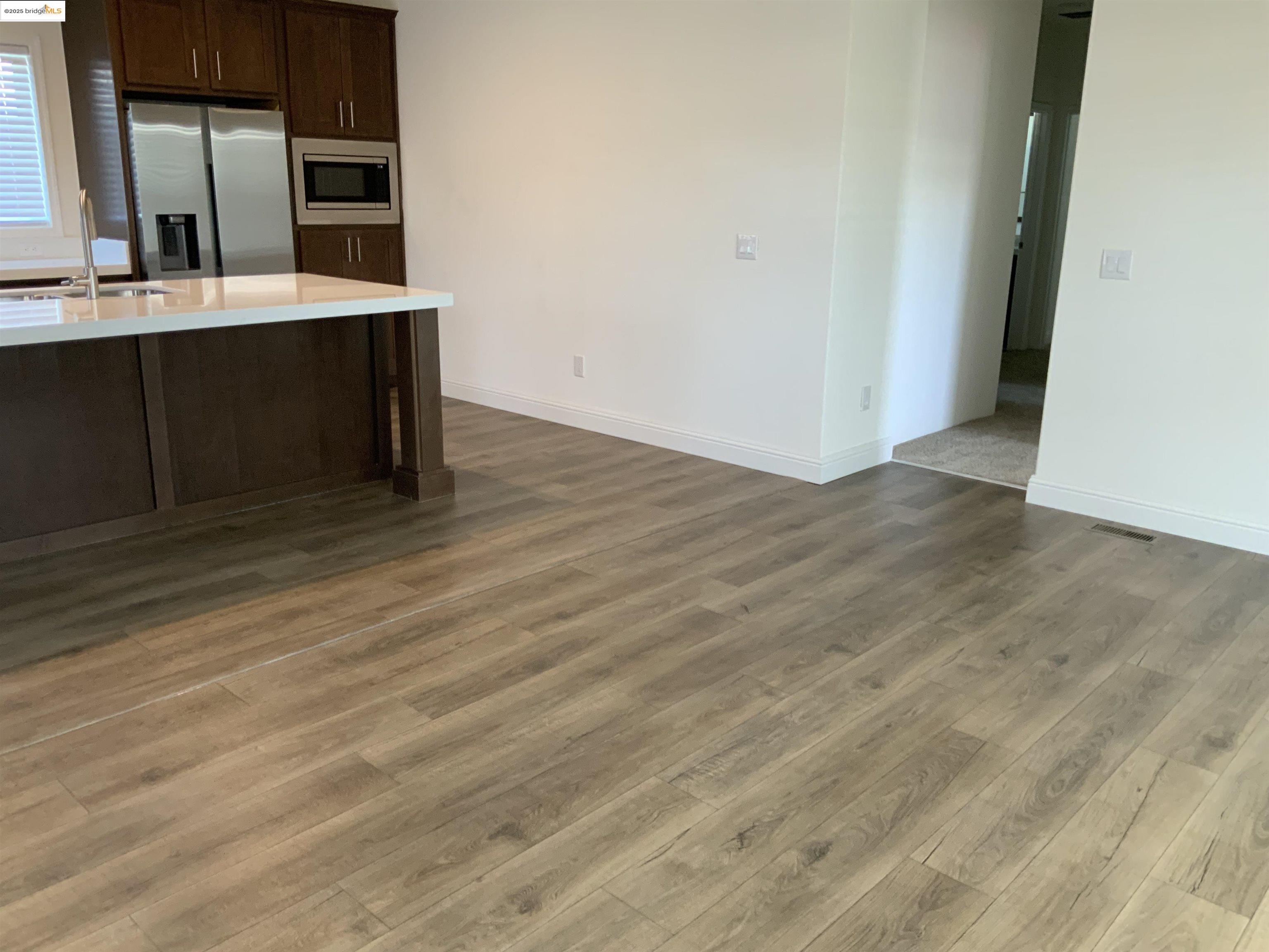 77 Hilo Drive Pittsburg, CA 94565 - Photo 7 of 23 a view of cabinets and wooden floor