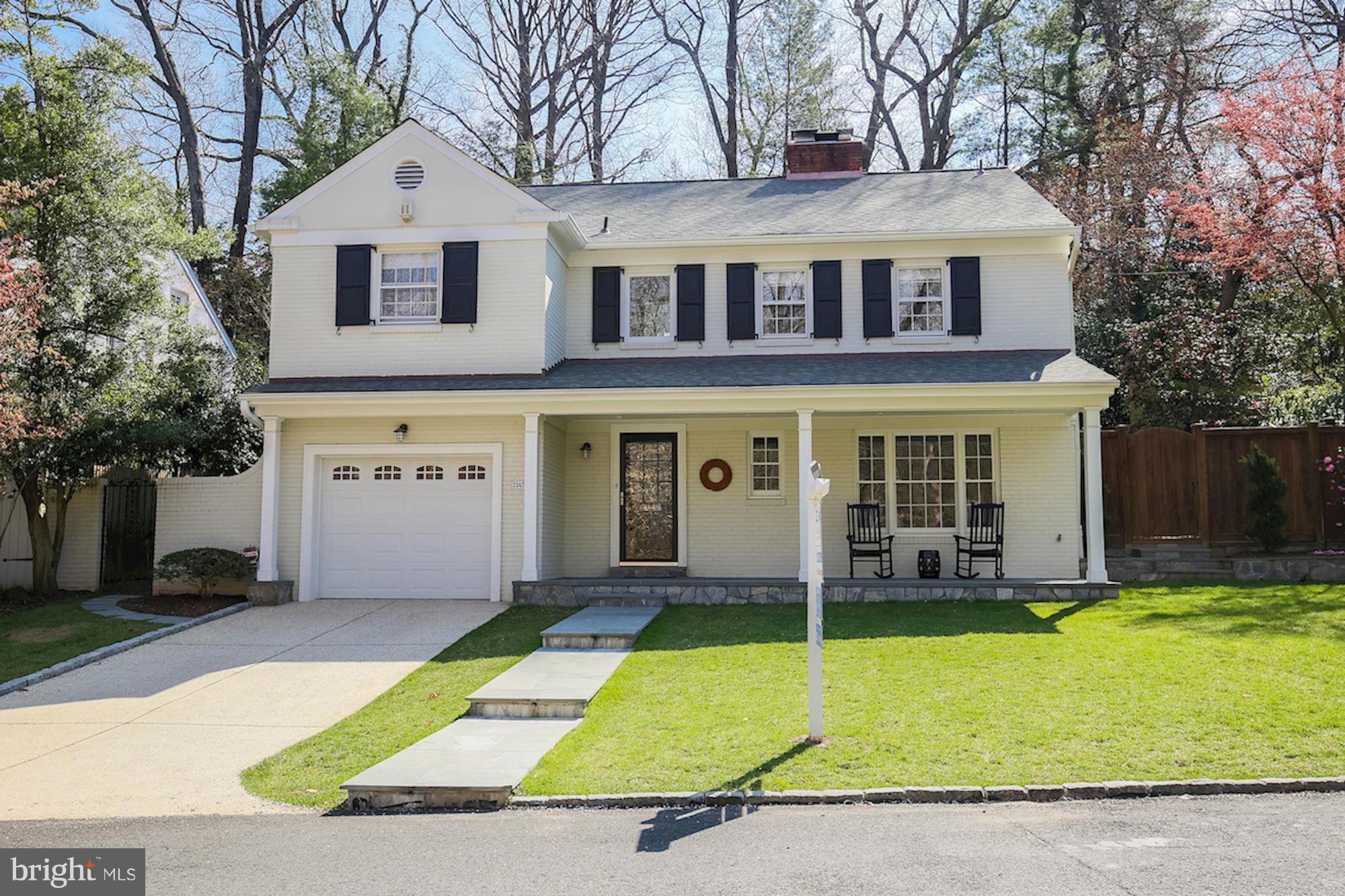 2347 49th Street Northwest Washington, DC 20007 - Photo 1 of 29 a view of a white house with a swimming pool and table under an umbrella
