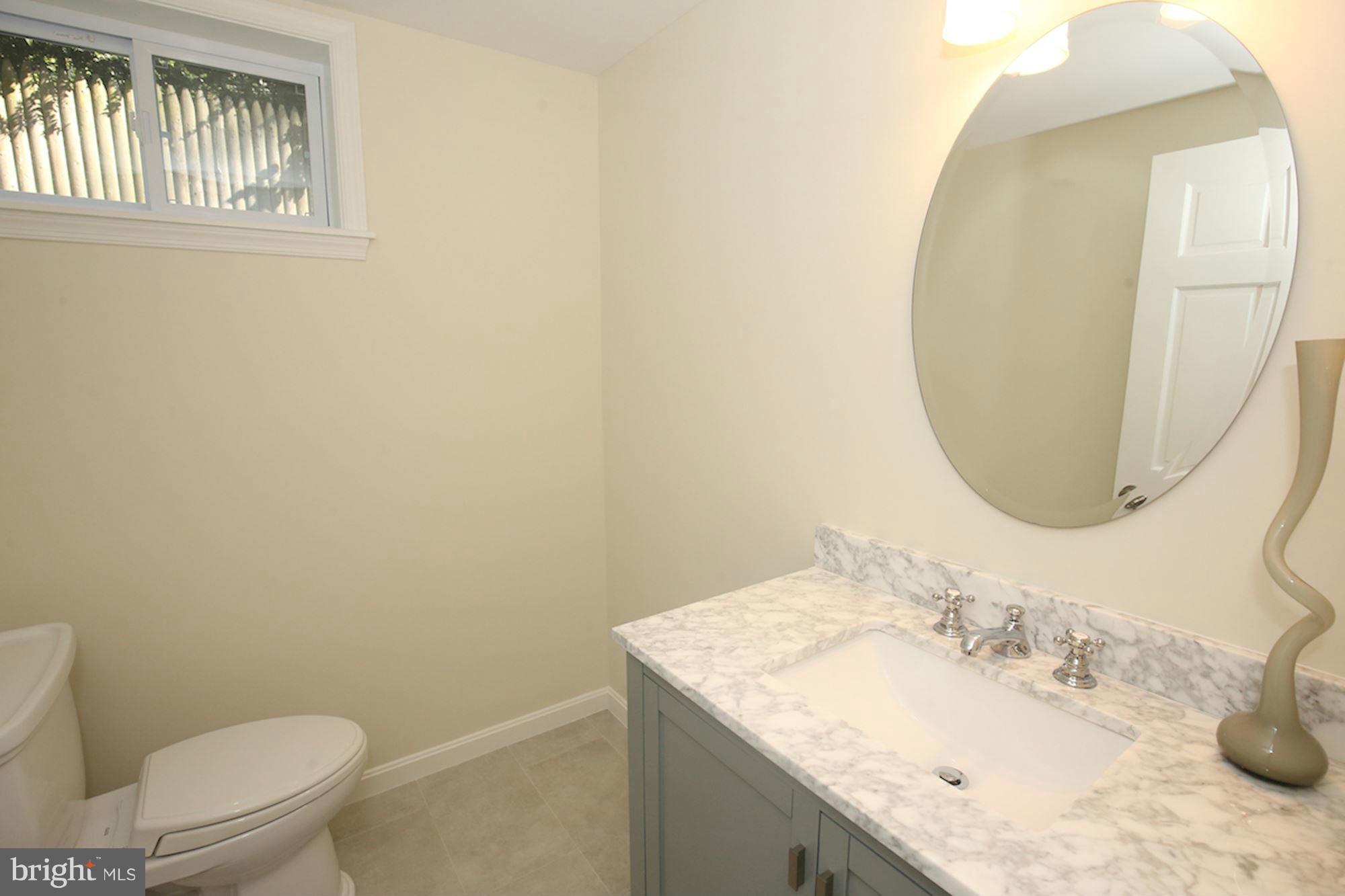2347 49th Street Northwest Washington, DC 20007 - Photo 18 of 29 a bathroom with a granite countertop sink mirror and toilet