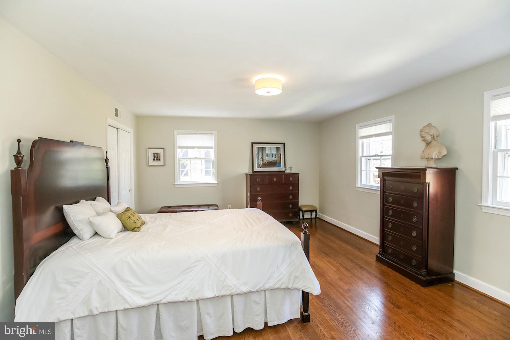 2347 49th Street Northwest Washington, DC 20007 - Photo 19 of 29 a bedroom with a bed and wooden floor