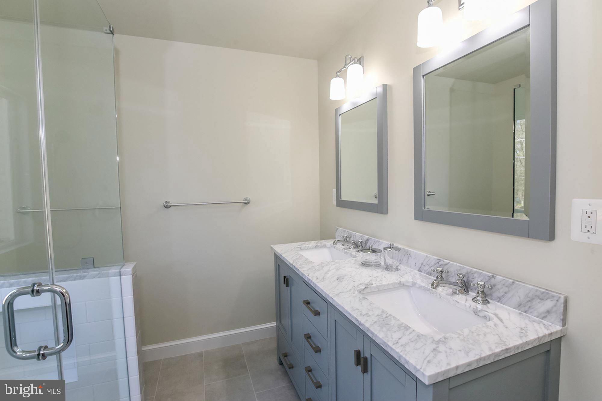2347 49th Street Northwest Washington, DC 20007 - Photo 20 of 29 a bathroom with a granite countertop sink and a mirror