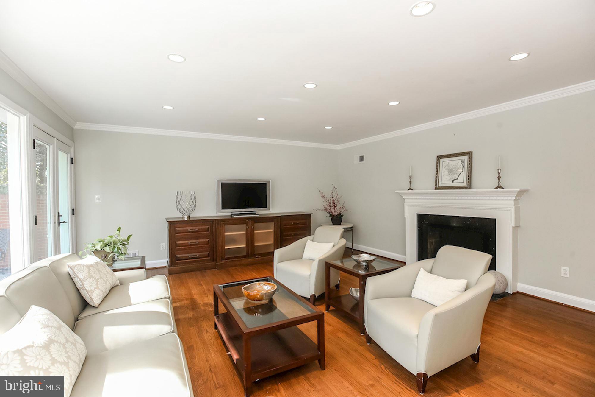 2347 49th Street Northwest Washington, DC 20007 - Photo 3 of 29 a living room with furniture and a fireplace