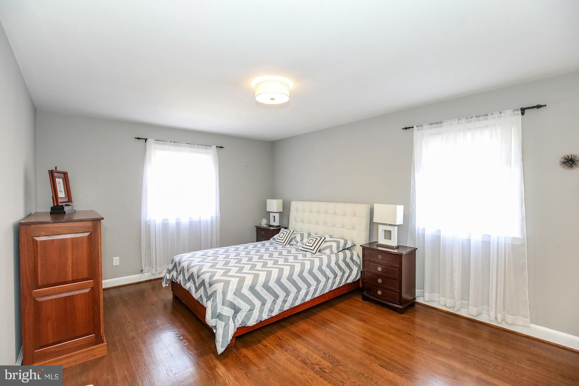 2347 49th Street Northwest Washington, DC 20007 - Photo 22 of 29 a bedroom with a bed and wooden floor