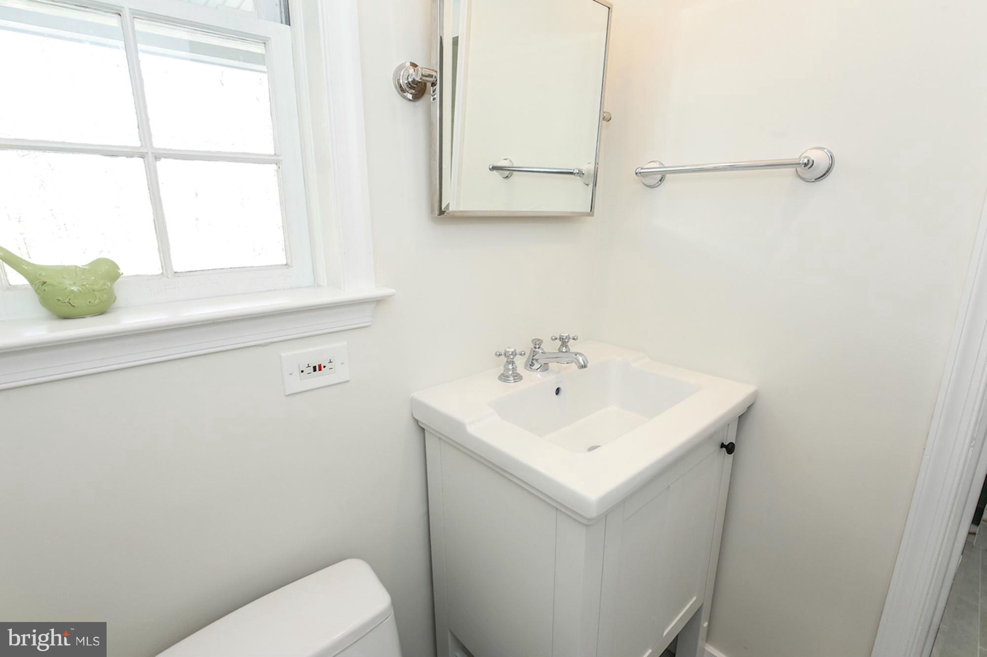 2347 49th Street Northwest Washington, DC 20007 - Photo 26 of 29 a bathroom with a sink a toilet and a window