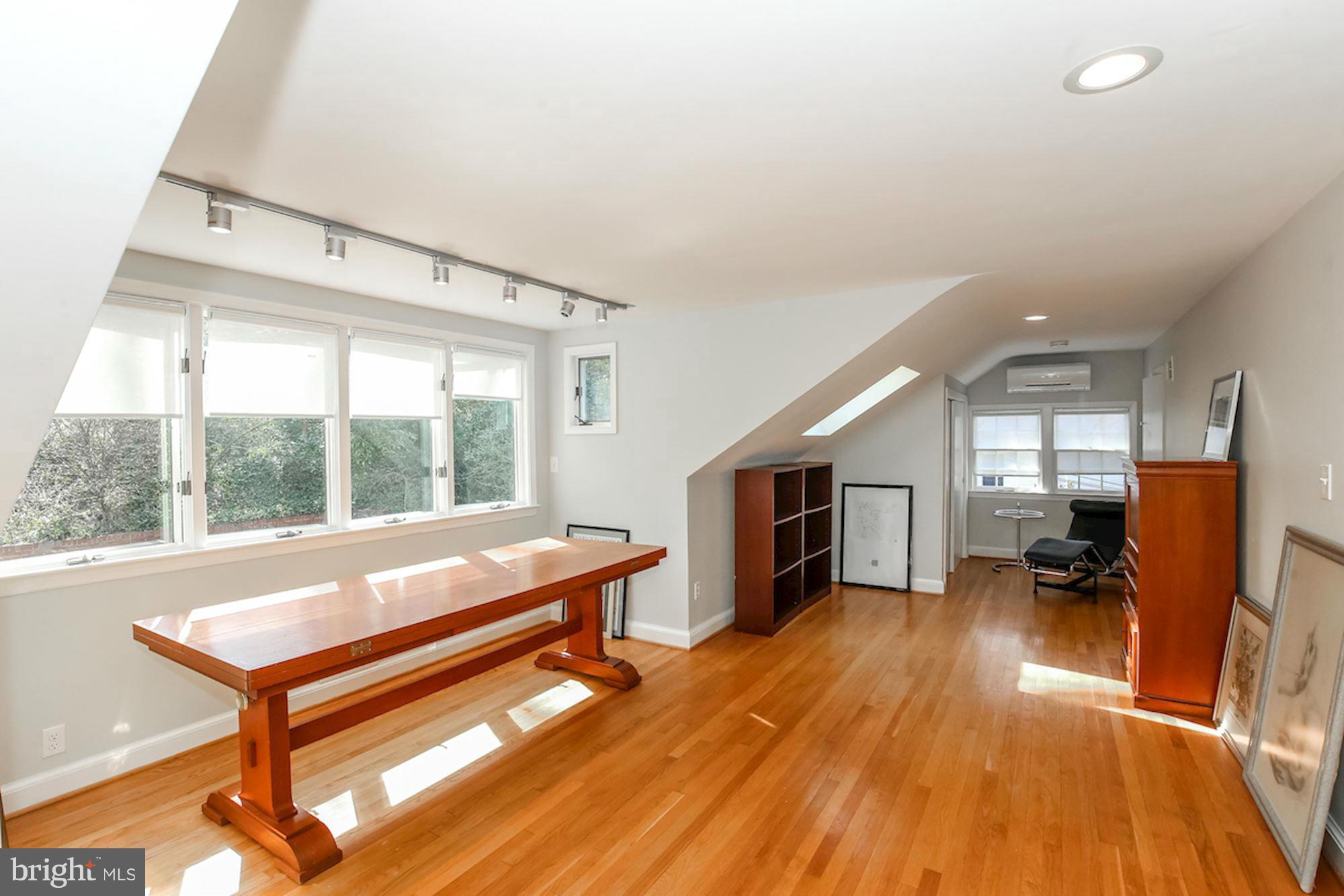 2347 49th Street Northwest Washington, DC 20007 - Photo 27 of 29 a living room with furniture a fireplace and large windows