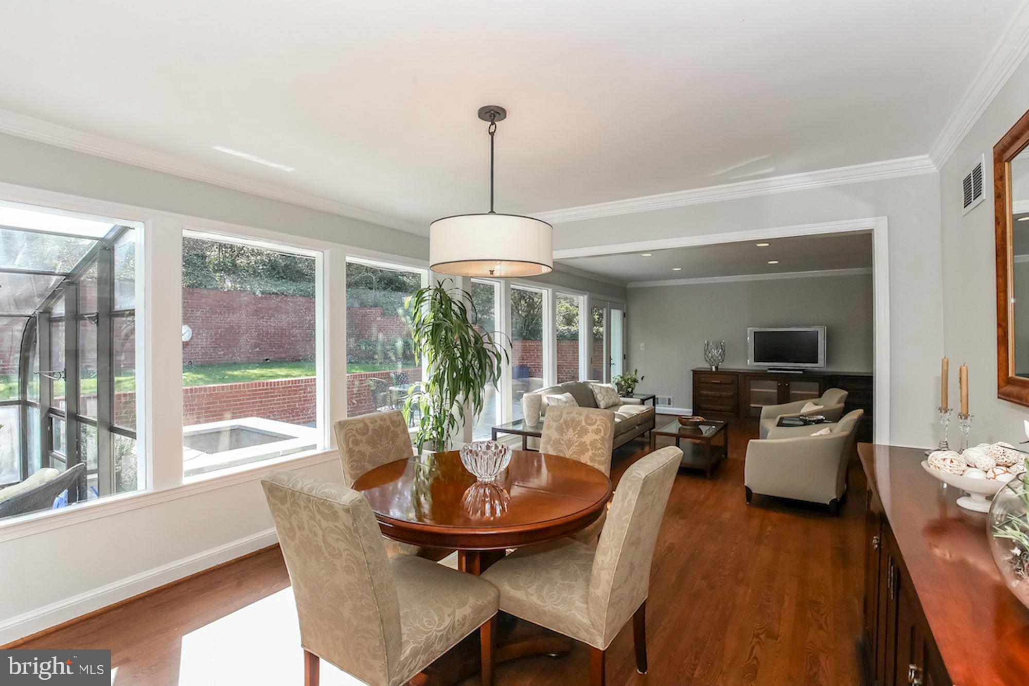 2347 49th Street Northwest Washington, DC 20007 - Photo 6 of 29 a dining room with furniture wooden floor and a chandelier