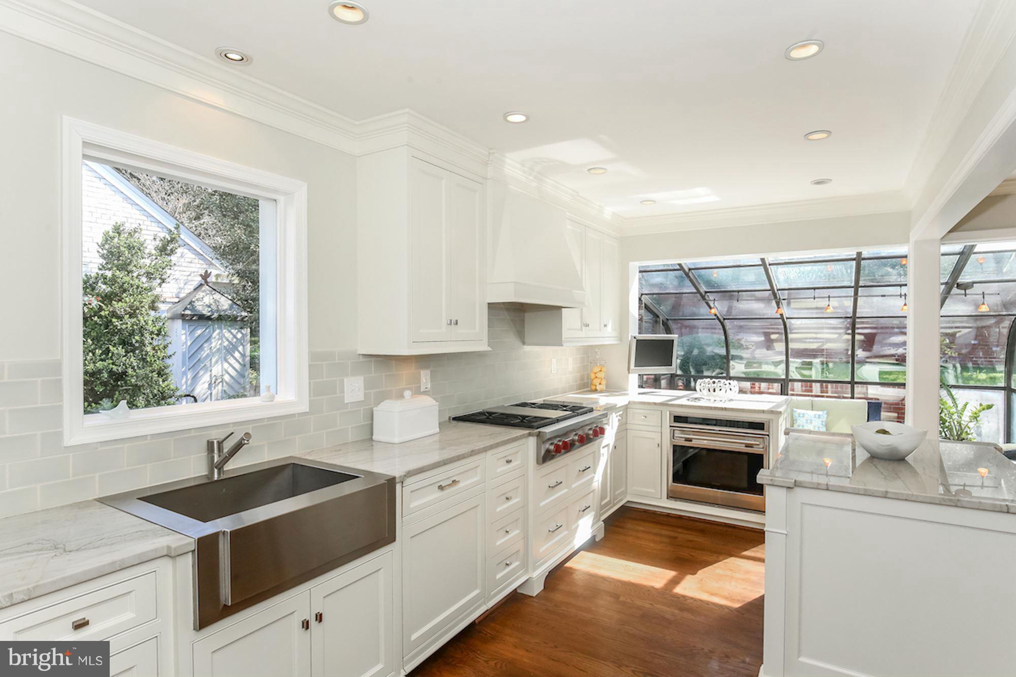 2347 49th Street Northwest Washington, DC 20007 - Photo 7 of 29 a kitchen with a sink stove top oven and cabinets