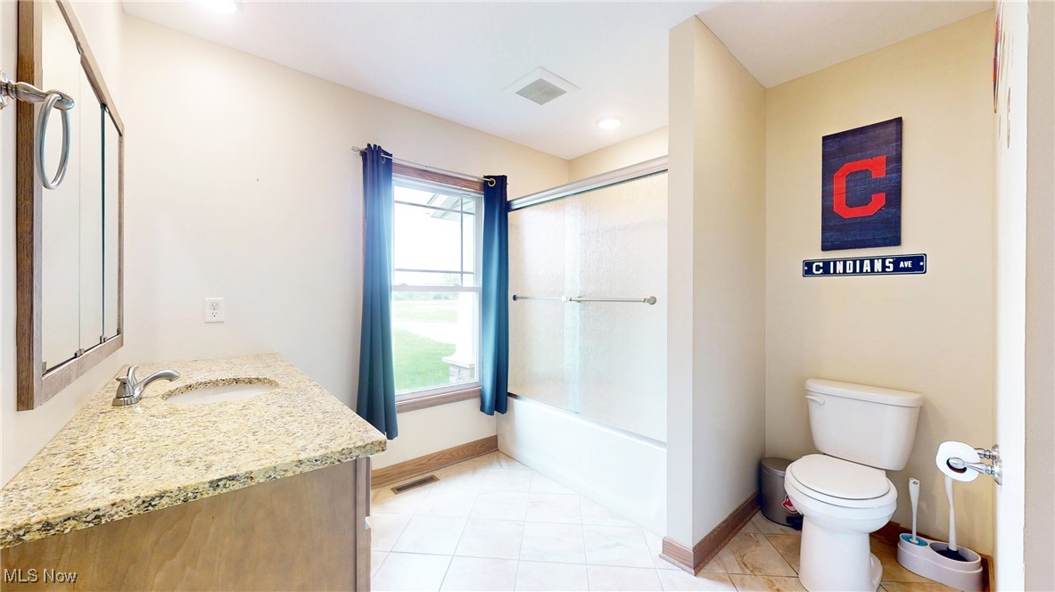 961 Industry Road Atwater, OH 44201 - Photo 33 of 50 Bathroom featuring vanity, combined bath / shower with glass door, and tile patterned floors