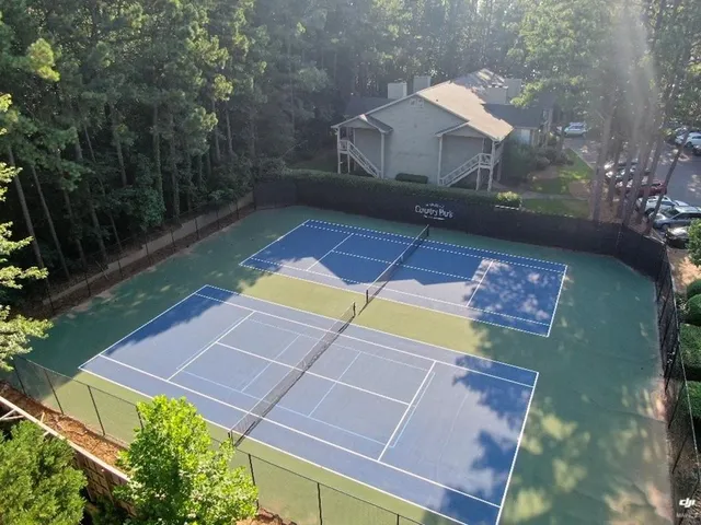a view of a dinning table and chairs under an umbrella