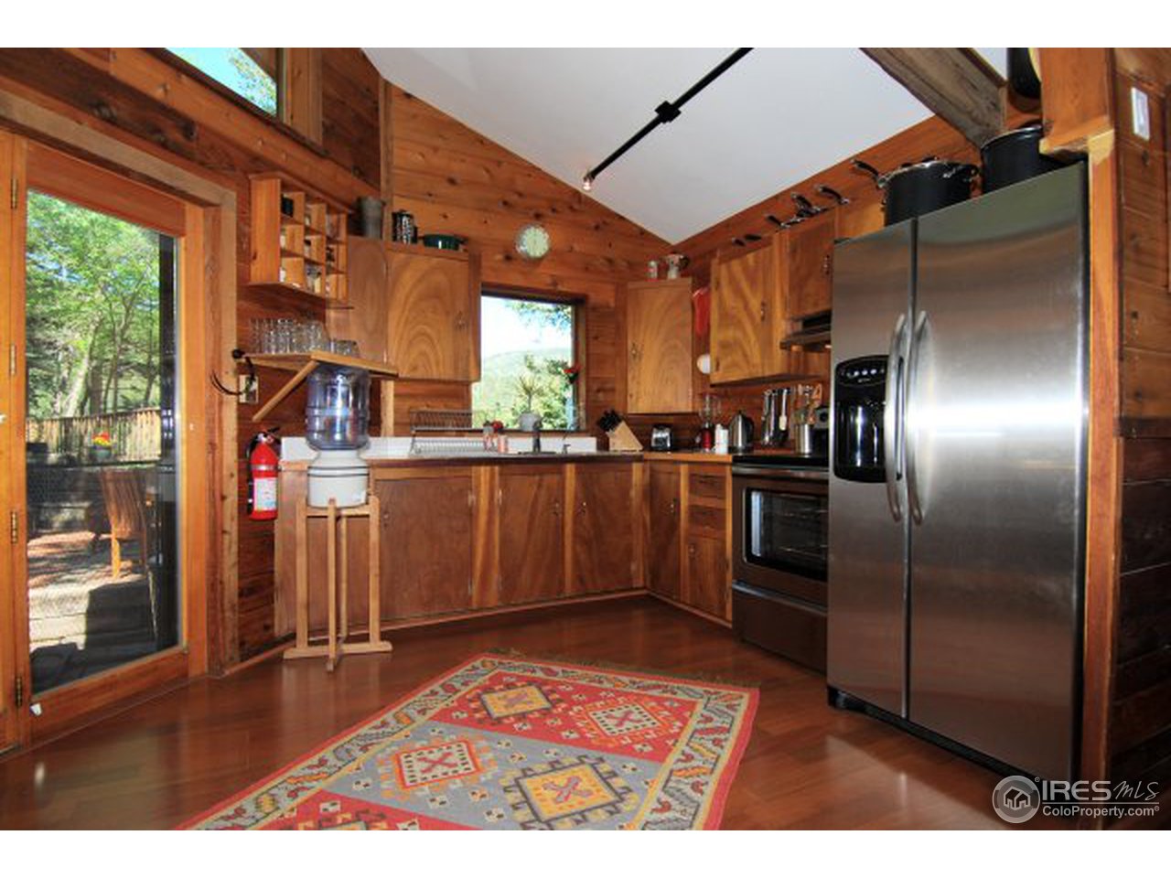 322 Alaska Road Boulder, CO 80302 - Photo 7 of 16 a kitchen with stainless steel appliances kitchen island granite countertop a refrigerator