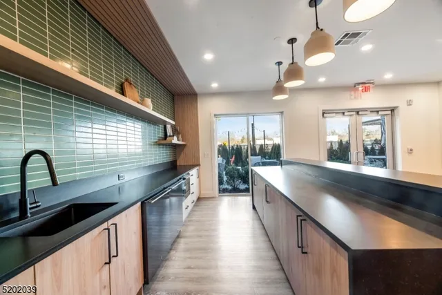 a large kitchen with stainless steel appliances a large counter top