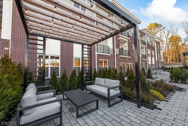 a view of a patio with table and chairs and potted plants