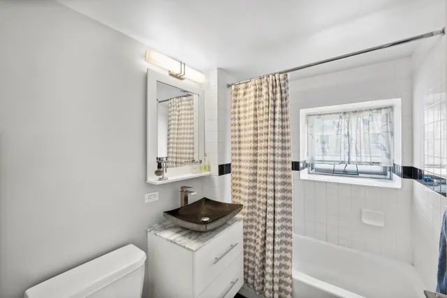 a bedroom with a bed and a window with wooden floor