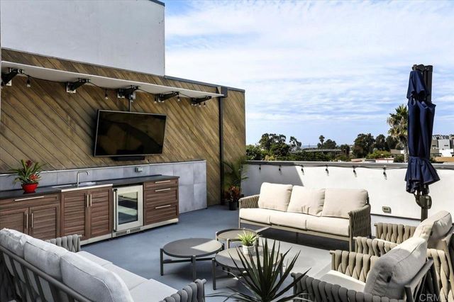 a balcony with furniture and a flat screen tv