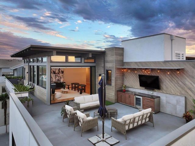 a view of living room kitchen with stainless steel appliances furniture stove and kitchen island