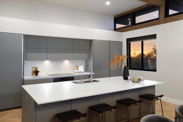 a kitchen with a sink cabinets and window
