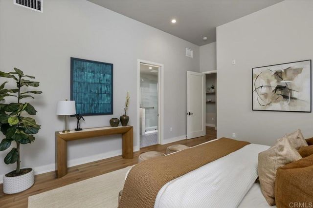 a bedroom with a bed and a couch