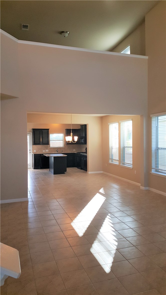 1509 Hamiltons Way Leander, TX 78641 - Photo 6 of 34 Family room with 2 story ceilings and open to dining and kitchen