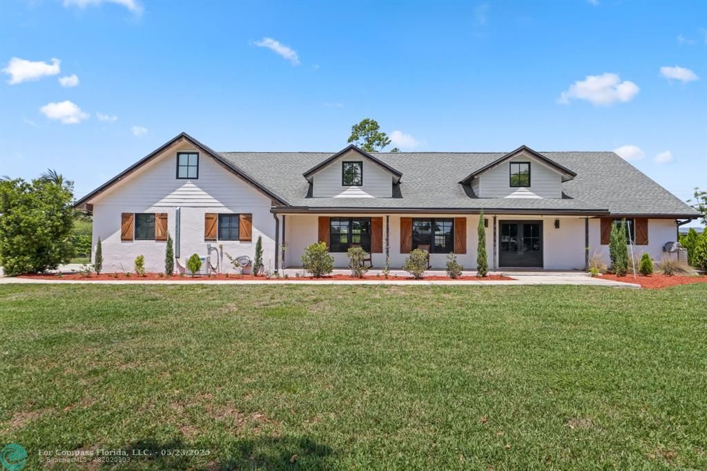 a front of a house with table and chairs